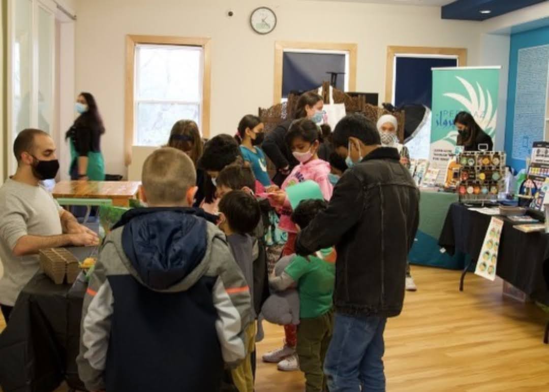 children gathered around craft table