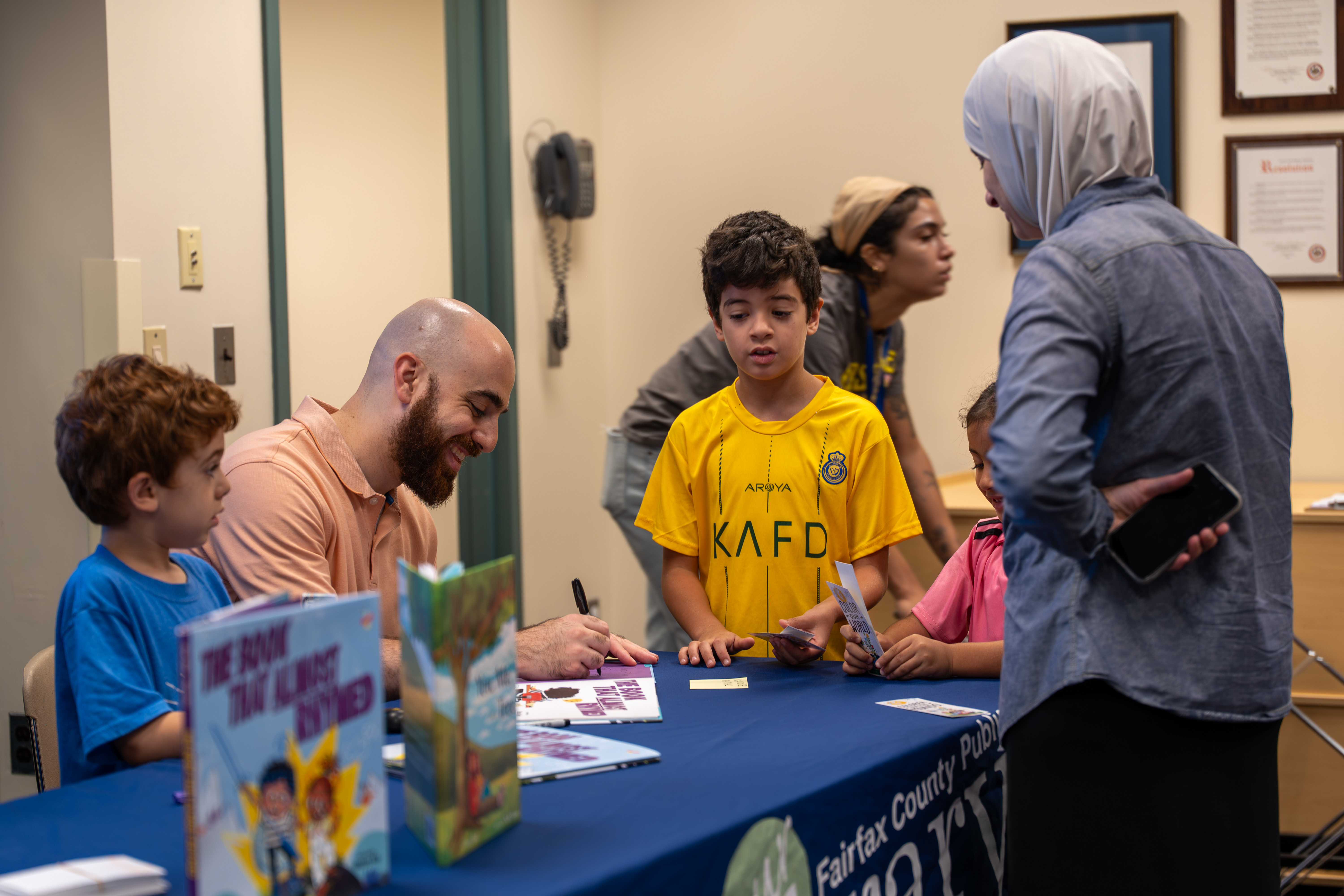Omar signing books