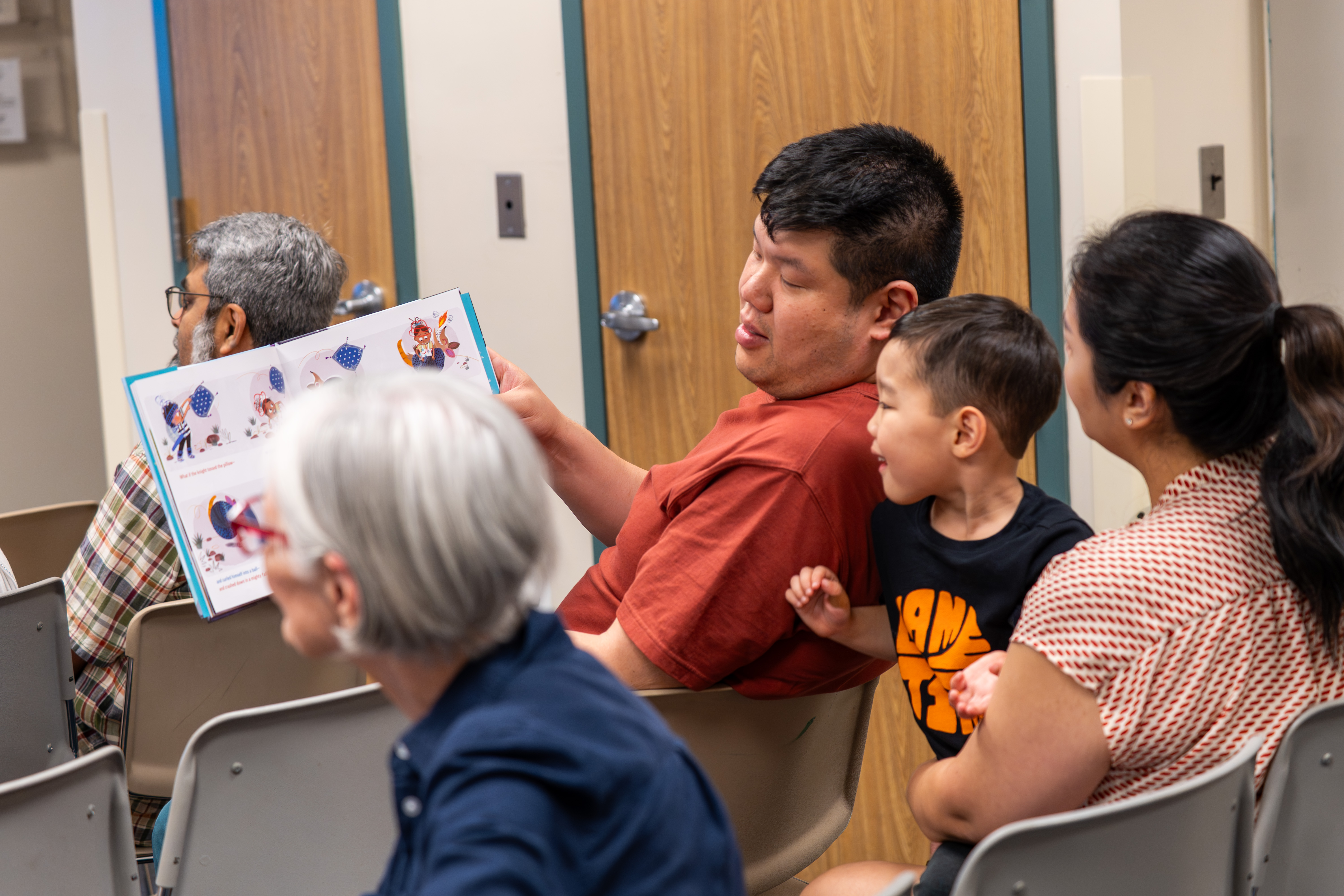 A family reading The Book That Almost Rhymed