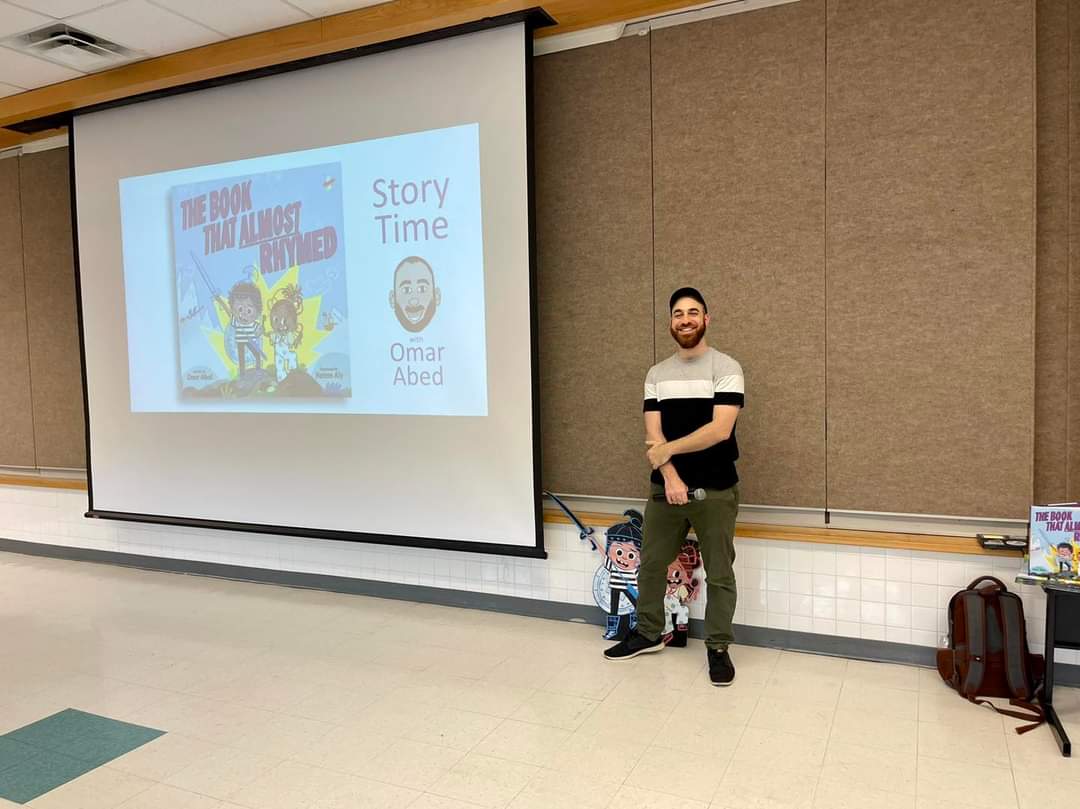 Omar presenting The Book That Almost Rhymed