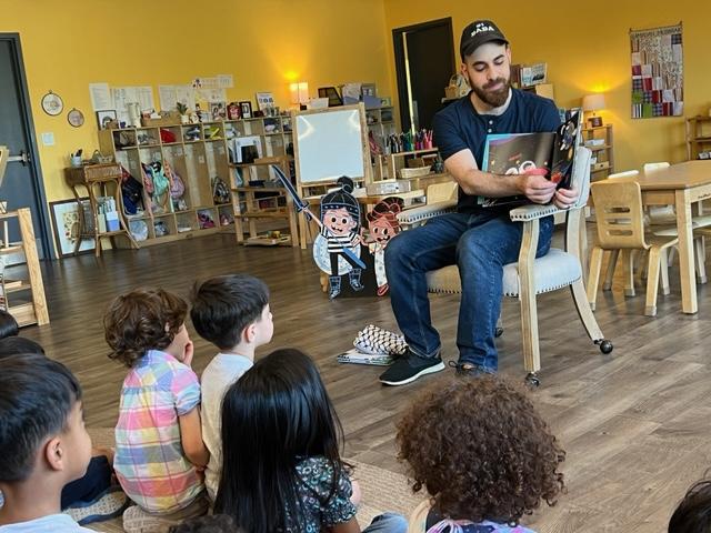 Omar reading The Book That Almost Rhymed at Medina Montessori