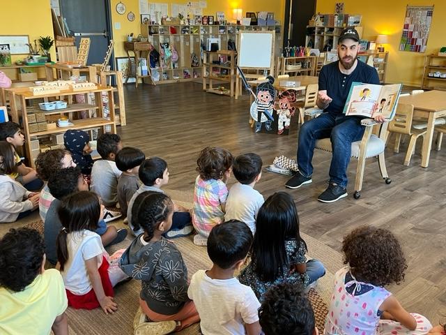 Omar reading The Book That Almost Rhymed at Medina Montessori